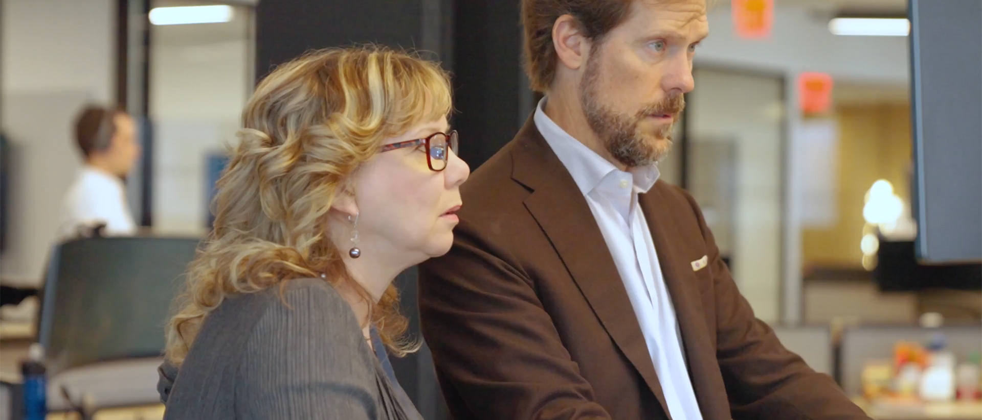 Video still image of two people working