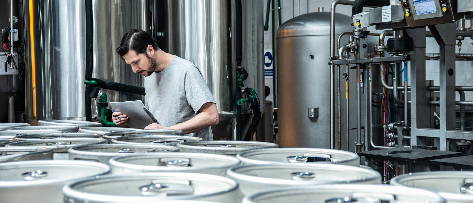 Keg Logistics header image man inspecting kegs