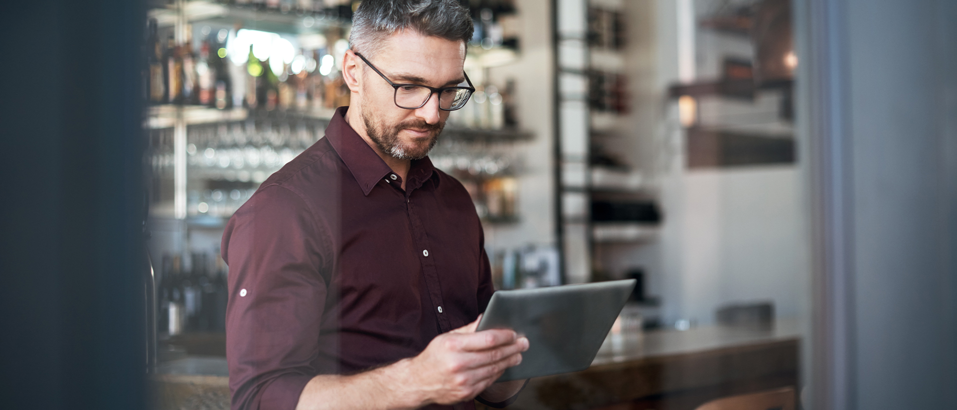 Corcentric header image man checking tablet in restaurant