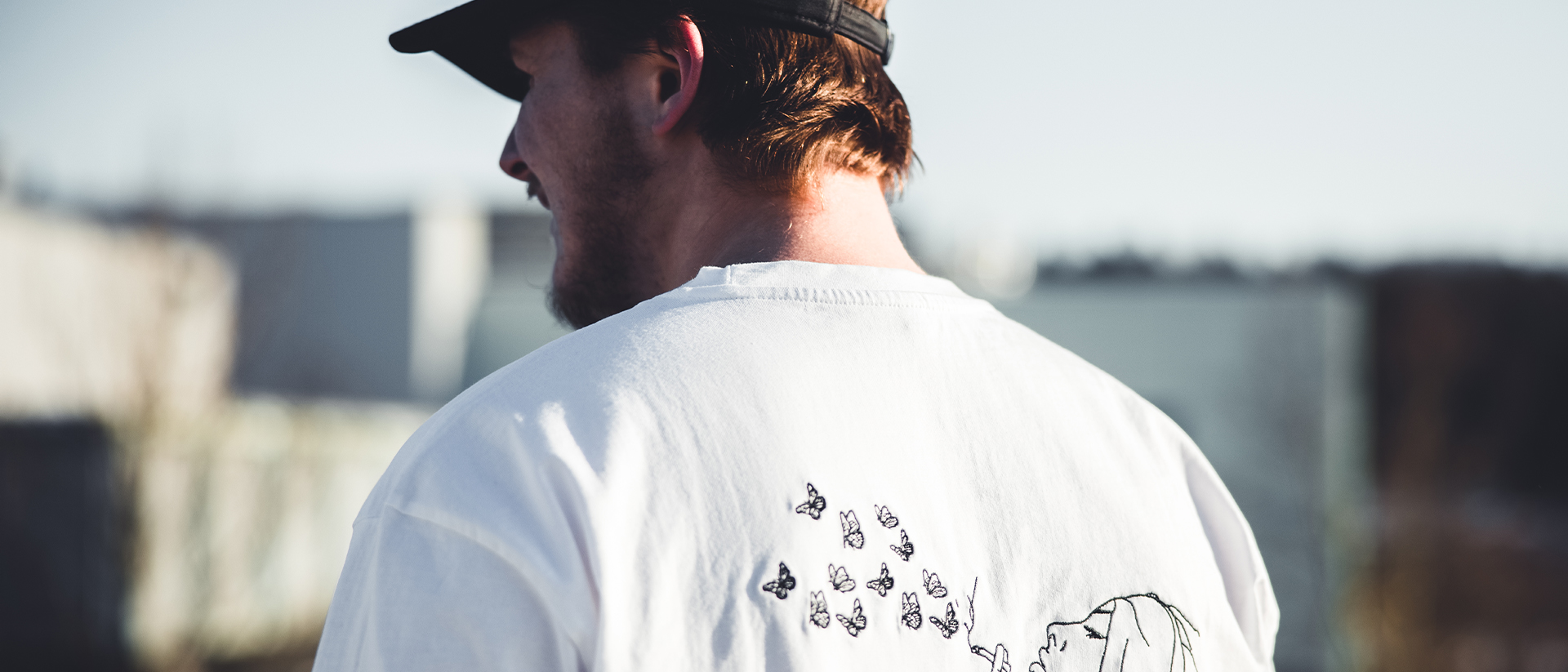 Printful Header 2 Man in tshirt and cap