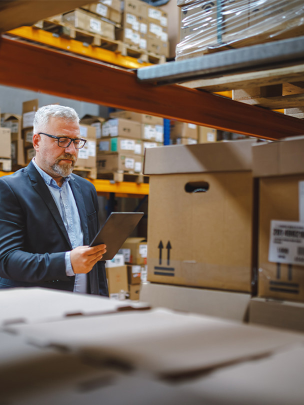 Procure Analytics Portrait 2 man working on tablet in warehouse