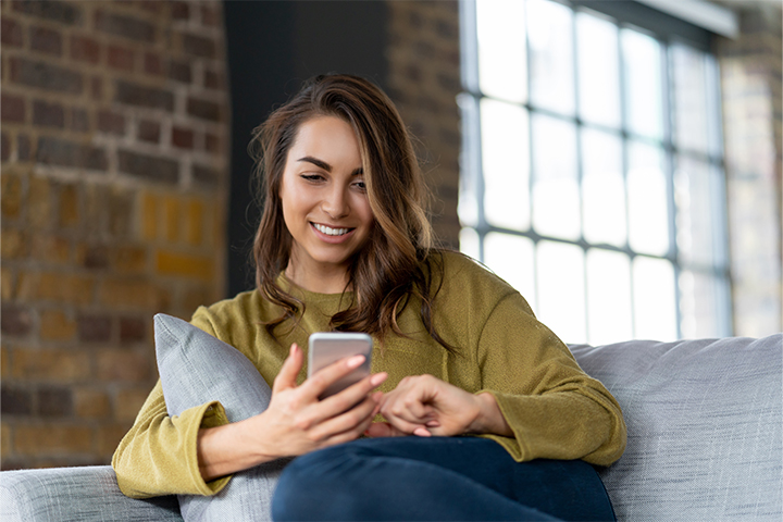 Single Digits Landscape 1 woman smiling at phone 