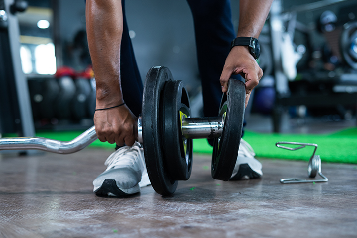 CDM Fitness Landscape 3 man setting up weights