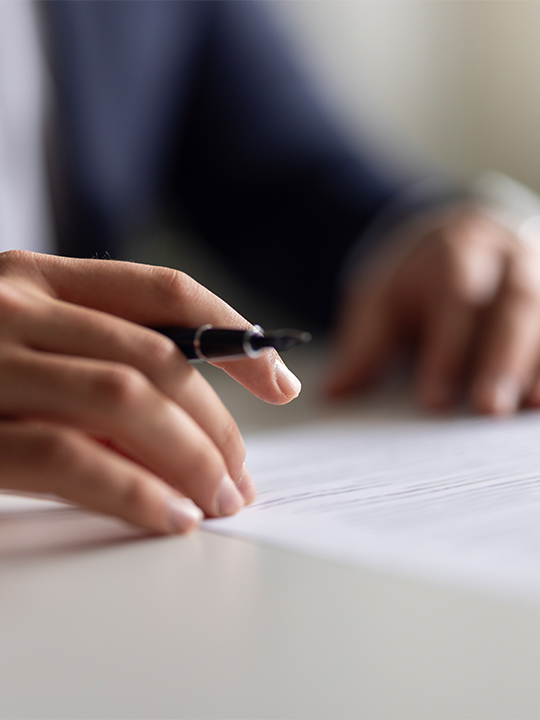 Sureprep Portrait 3 hands holding pen over paperwork