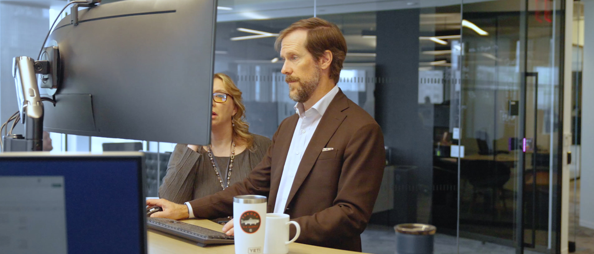 Video still of people working on a computer